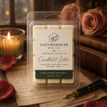 Candlelit Letter Wax Melts in clear clamshell packaging sitting on vintage paper with a fountain pen nearby, surrounded by a lit candle, rose petals, and pink roses for a warm, cozy atmosphere.