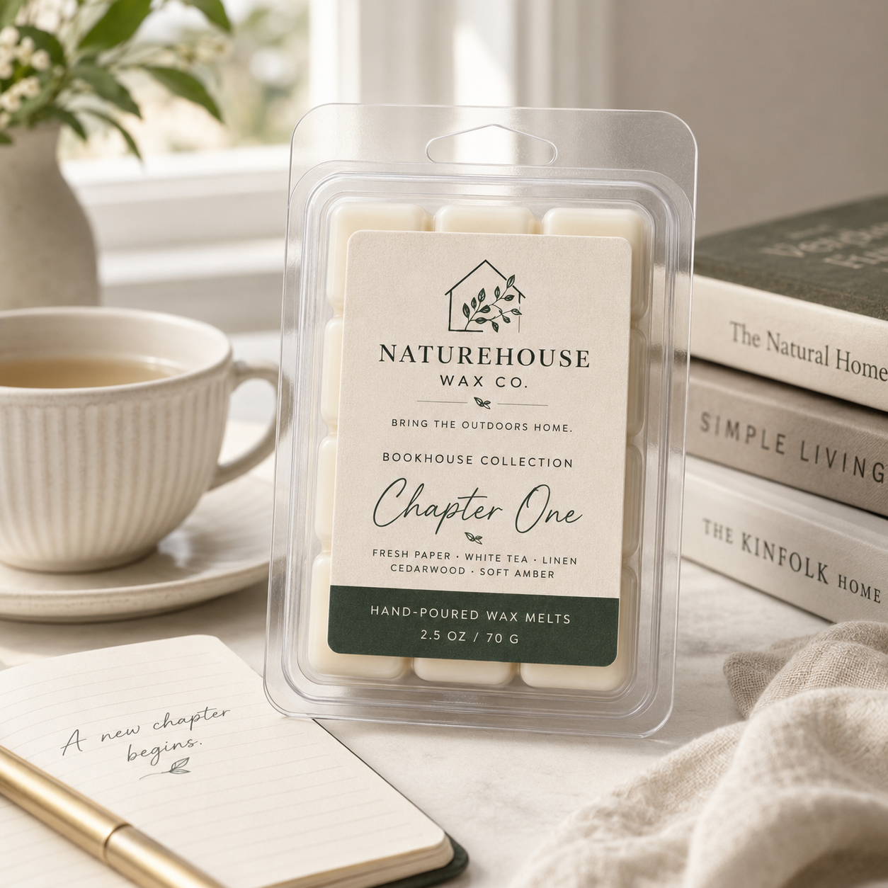 Clear clamshell package of Chapter One Wax Melts by Naturehouse Wax Company placed on a cozy tabletop setting with books, a notebook, and a cup of tea in the background.