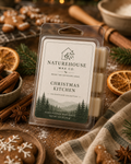 Naturehouse Wax Company Christmas Kitchen Wax Melts package displayed with dried orange slices, cinnamon sticks, star anise, and holiday cookies on a rustic wooden surface.