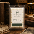 Old Bookshop Wax Melts by Naturehouse Wax Co., hand-poured wax tarts with aged paper, oak, amber, leather, and tonka bean scents, surrounded by vintage books and cozy lighting.